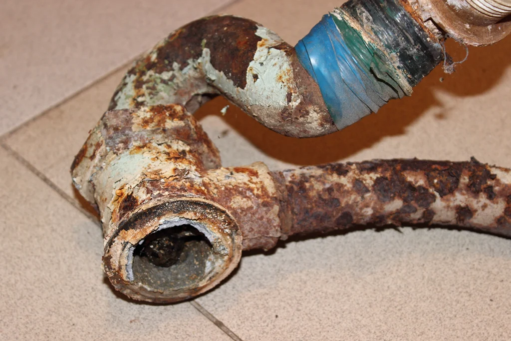 Old drum trap with rust and corrosion removed during plumbing repair