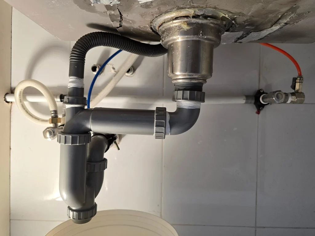 Under-sink plumbing with a visible P-trap drain assembly for an S trap vs P trap comparison blog