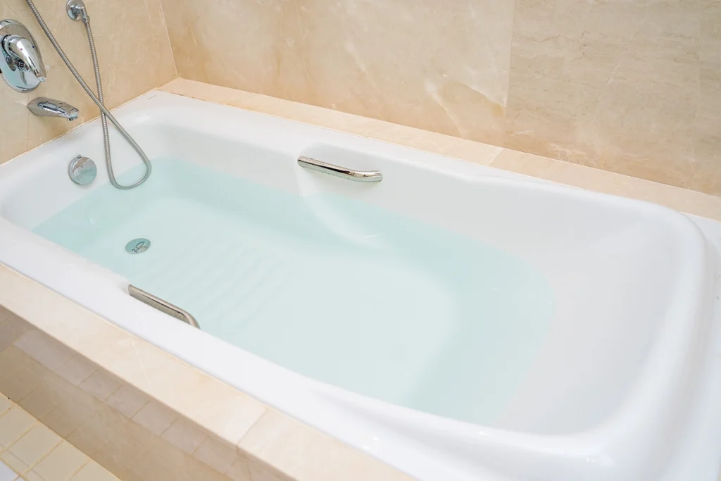 Bathtub drain clogged with standing water in the tub